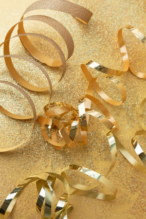 New Year and Christmas background. Golden festival tinsel nad shadows on a yellow background. Top viewの写真素材
