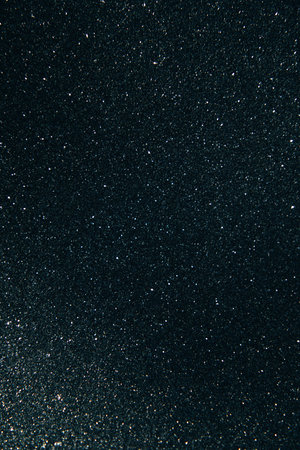 Shining sparkling black blurred background for holiday design. Christmas abstract sparkles, selective focusの写真素材