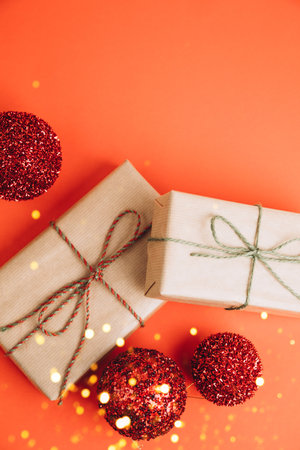 Greeting Christmas background. Gifts wrapping in brown paper on a red background. Top viewの写真素材