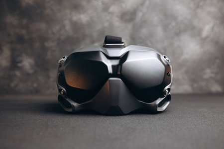 Close-up of black virtual reality glasses on a dark concrete background. Glasses for controlling drones. Front viewの写真素材
