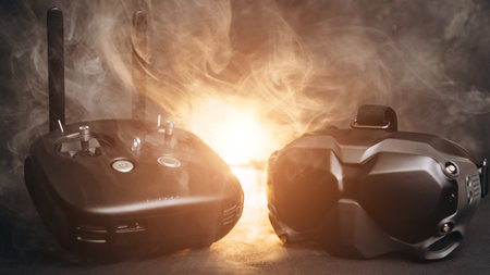 Close-up of black virtual reality glasses and remote control panel on a dark background. Glasses for...