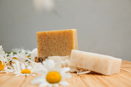 Handmade soap from natural ingredients, various herbs, chamomile. Concept of sustainable use, bath products on a wooden background. Front viewの写真素材