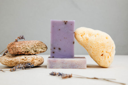 Handmade soap from natural ingredients, various herbs, lavender. Concept of sustainable use, bath product on concrete background. Front viewの写真素材