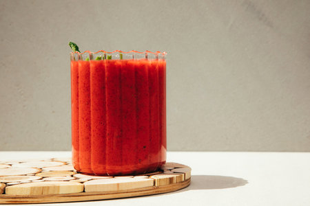 Fruit smoothie in transparent cups. Red strawberry smoothie on a concrete background. The concept of healthy eating. Front viewの写真素材
