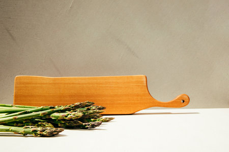 Fresh ripe green asparagus on a concrete background. Harvest asparagus, bunches. Healthy eating concept. Front viewの写真素材