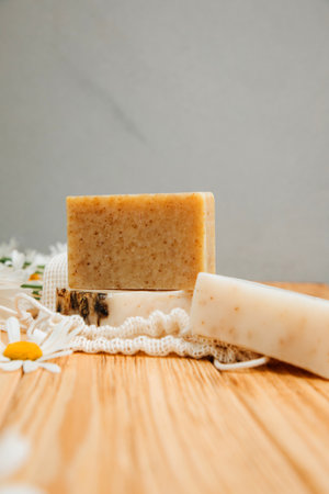 Handmade soap from natural ingredients, various herbs, chamomile. Concept of sustainable use, bath products on a wooden background. Front viewの写真素材