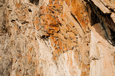 Uneven, rough stone texture, retractable rock close-up. Natural background for design. Front viewの写真素材