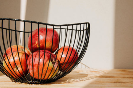 Red apples in blackdeep bowl on a light background. Autumn composition, harvest of apples, juice red apples. Front viewの写真素材
