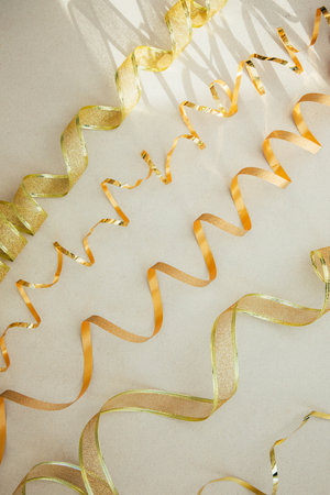 New Year and Christmas background. Golden festival tinsel nad shadows on a grey background. Top viewの写真素材
