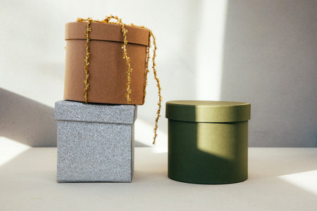 Christmas, festive background. Green, brown, silver gifts boxes with on a grey background. Front viewの写真素材