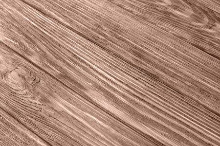 Color of the year, mocha mousse. Brown textured wooden background, burnt wood. Background of wooden boards for designの写真素材