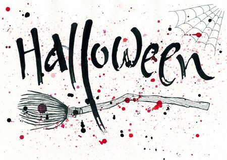 Halloween ink brush lettering with a broom and a spiderwebの写真素材