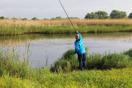 Fisherman on river bankの写真素材