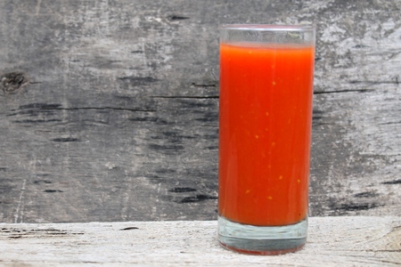 Tomato juice on wooden backgroundの写真素材