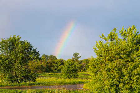 Rural landscape with rainbowの写真素材