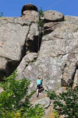 Boy climbing on the rockの写真素材