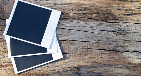 Old blank photos on the rustic wooden backgroundの写真素材