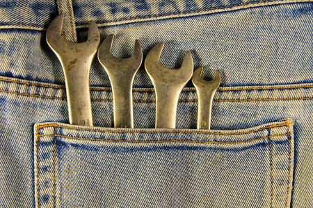 Wrench tools in the blue pocket jeans