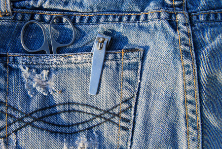 Nail scissors and clippers in the blue jeans pocketの写真素材