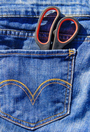 Pair of scissors in the pocket of blue jeansの写真素材
