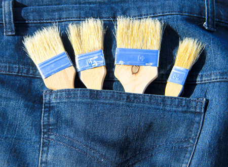 Paintbrush in the pocket of blue jeans