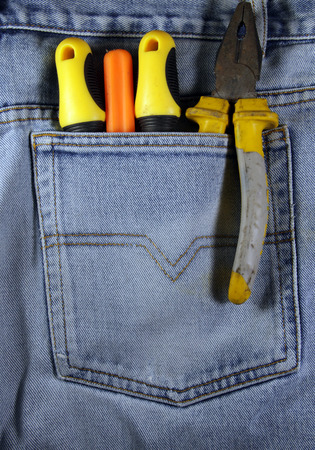 Pliers and screwdrivers in the jeans pocketの写真素材