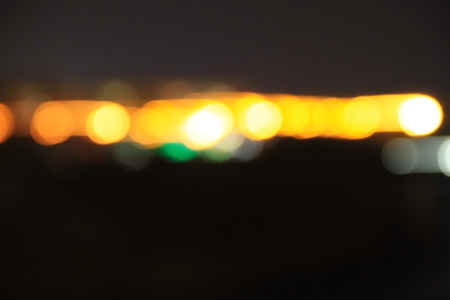 Abstract background of blurred city lights with bokeh effectの写真素材