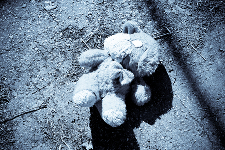 Abandoned dog doll on the pavement. Black-white toneの写真素材