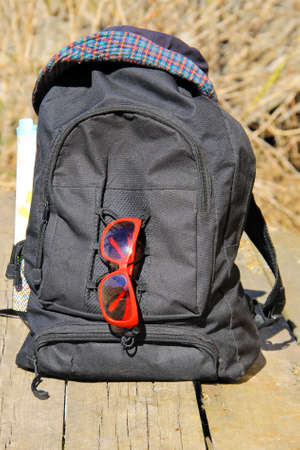 Travel concept. Backpack with hat, red sunglasses and mapの写真素材