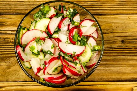 Radish salad in glass bowl on wooden tableの写真素材