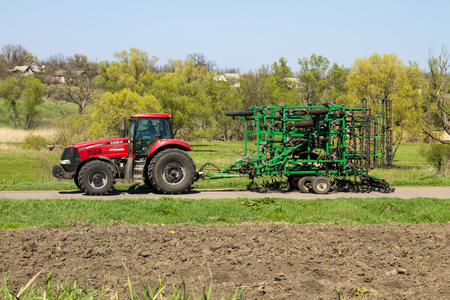 Kirovograd region, Ukraine - April 26, 2017: Tractor with cultivator on the rural roadのeditorial素材