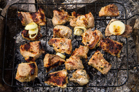 Pork meat roasting on the grill. Meat on the coals, barbeque close upの写真素材