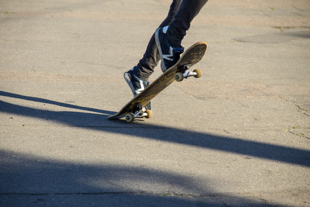 Skateboarder legs riding skateboard at skateparkの写真素材