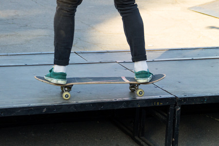 Skateboarder legs riding skateboard at skateparkの写真素材