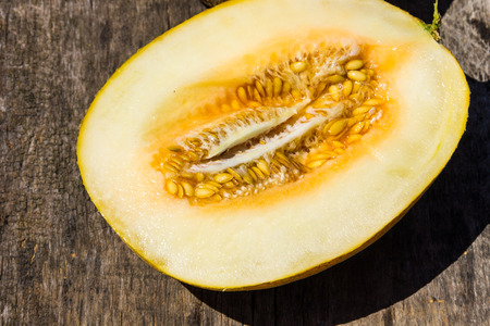 Half of melon on rustic wooden backgroundの写真素材