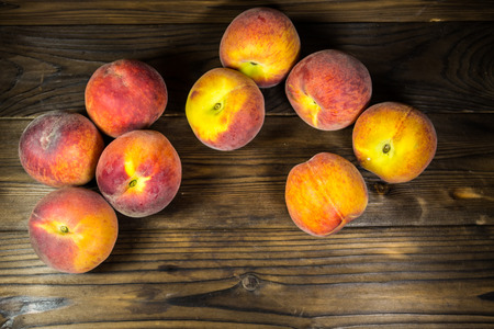 Ripe peaches on wooden tableの写真素材