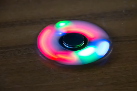 Fidget spinner toy with led light on tableの写真素材