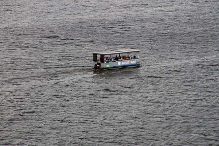 Kremenchug, Ukraine - July 29, 2017: Tourist boat with people on board in the Dnieper river