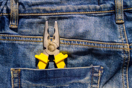 Pliers to repair in pocket of blue jeans