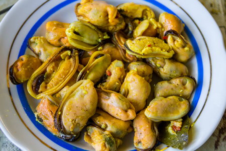 Tasty pickled mussels on a plate close-upの写真素材