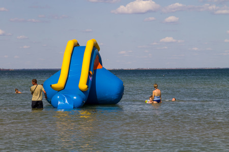 Genichesk, Ukraine - August 24, 2017: Inflatable water slide in Azov sea. Favorite vacation spot of children and adultsのeditorial素材