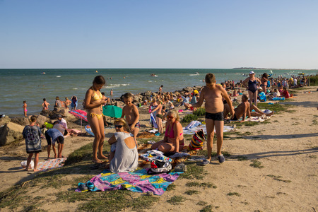 Genichesk, Ukraine - August 25, 2017: Unknown people enjoy on the beach of Azov seaのeditorial素材