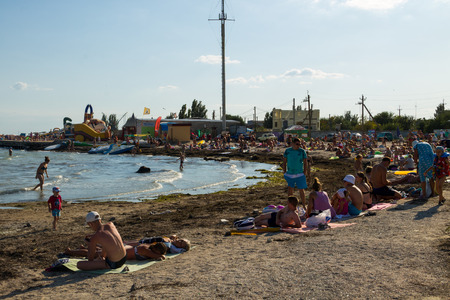 Genichesk, Ukraine - August 25, 2017: Unknown people enjoy on the beach of Azov seaのeditorial素材