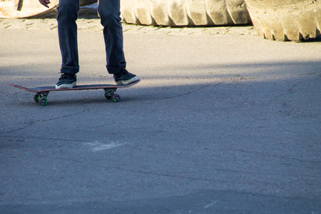 Skateboarder legs riding skateboard at skateparkの写真素材