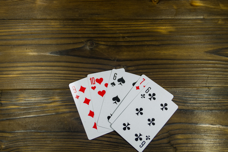 Playing cards on wooden background