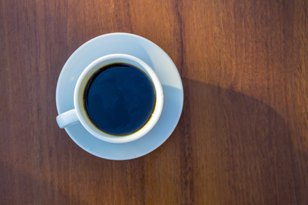 Cup of coffee on wooden table. Top viewの写真素材