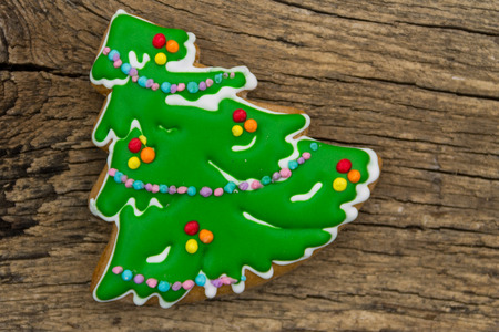 Christmas gingerbread shaped as a Christmas tree on rustic wooden tableの写真素材