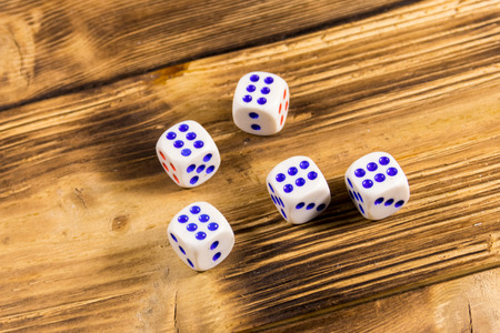 White dice on wooden table. Game of chance concept