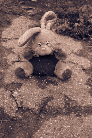 Abandoned bunny doll on the pavement. Black-white toneの写真素材