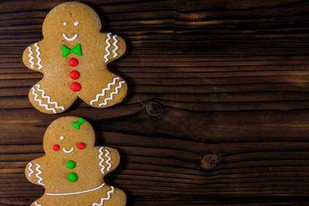 Christmas gingerbread couple cookies on wooden table. Top view